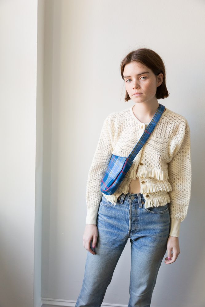 Vintage fringe knit sweater, vintage Levi's from Courtyard LA, plaid bag from Gabriel for Sach.